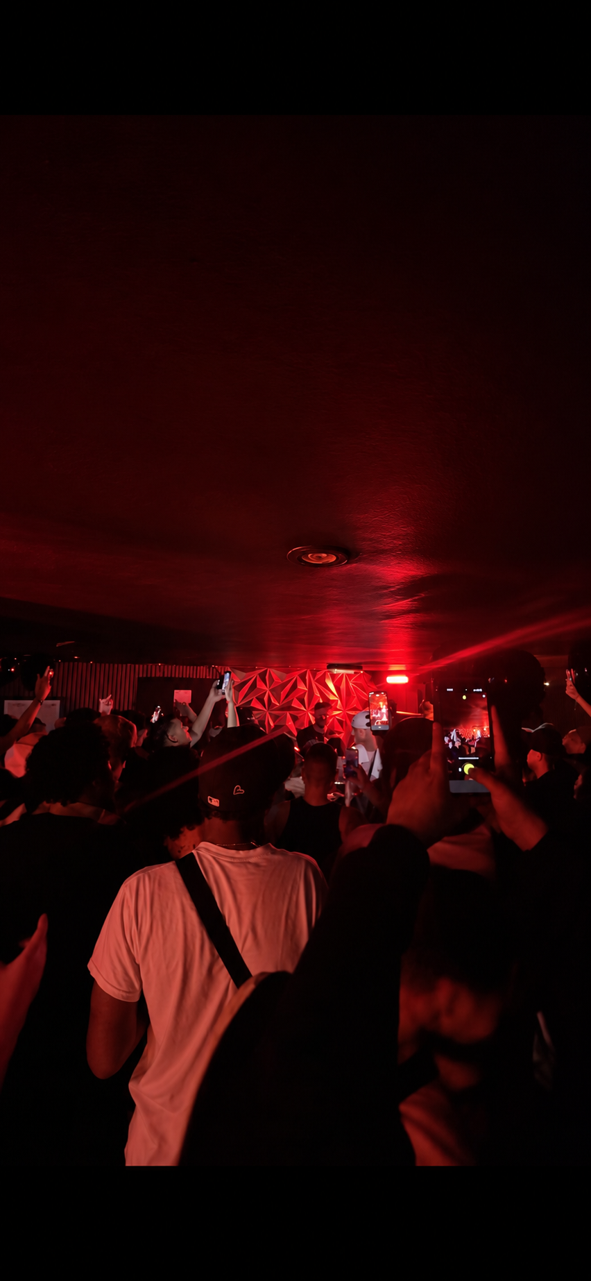 The Ronin Room crowd dancing under red lights late at night